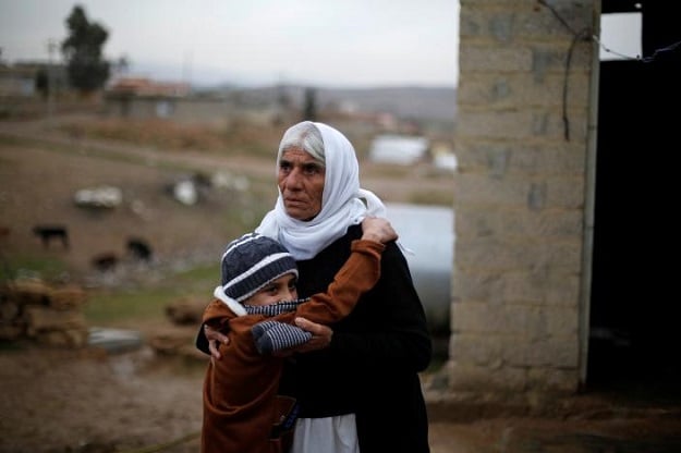 Ayman hugs his grandmother after he was returned to his Yazidi family, in Duhok, Iraq, January 31, 2017. PHOTO: REUTERS