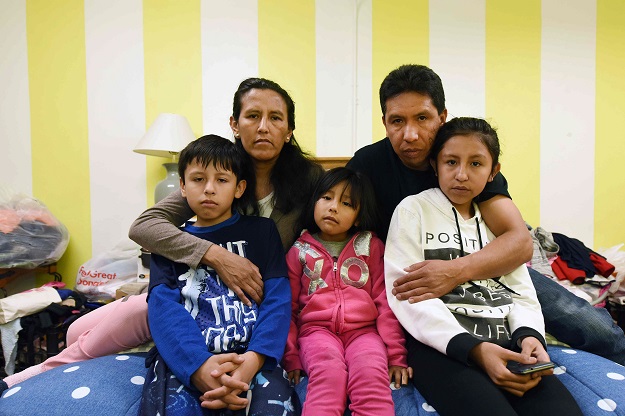 Jeanette Vizguerra (2nd L) poses with her husband Salvador Baez (2nd R) and their children, Roberto Baez (L), 10, Zury Baez (C), 6, Luna Baez in the First Unitarian Society Church of Denver in Denver, Colorado on February 16, 2017. PHOTO: AFP