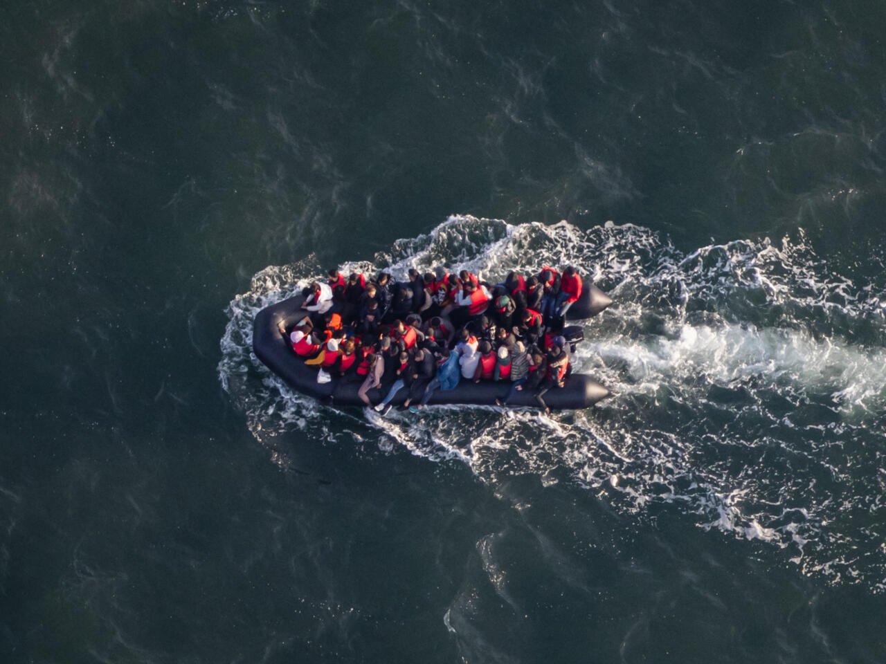 an aerial shot taken in september 2023 by french border police shows migrants on a smuggling dinghy attempting to cross the english channel from le touquet northern france photo afp