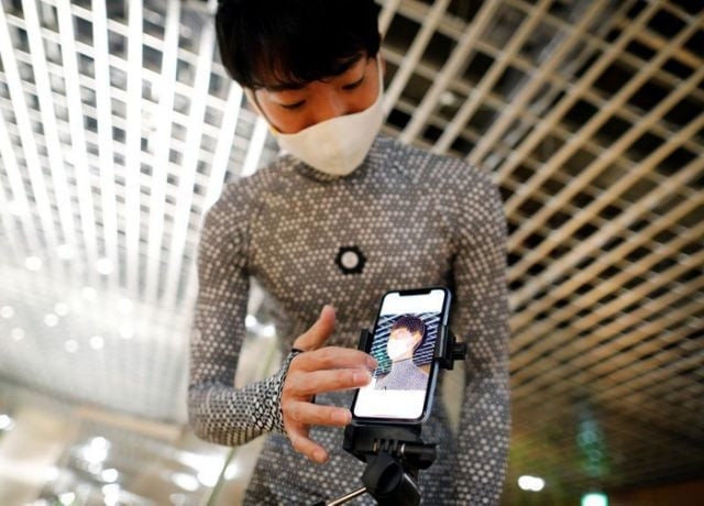 an employee of online fashion retailer zozo inc poses for a photograph as he demonstrates the company s zozosuit 2 a 3d body measurement suit at their tokyo office in tokyo japan photo reuters an employee of online fashion retailer zozo inc poses for a photograph as he demonstrates the company s zozosuit 2 a 3d body measurement suit at their tokyo office in tokyo japan photo reuters