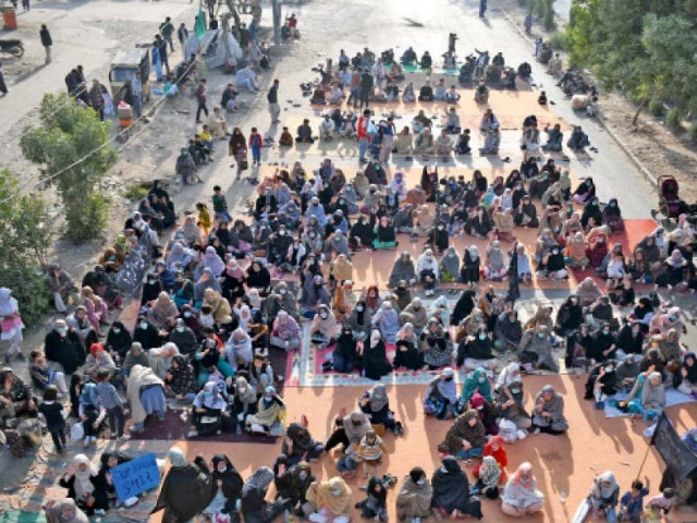 members of the hazara community stage a sit in on university road to protest the killing of 11 miners in machh balochistan photo online members of the hazara community stage a sit in on university road to protest the killing of 11 miners in machh balochistan photo online