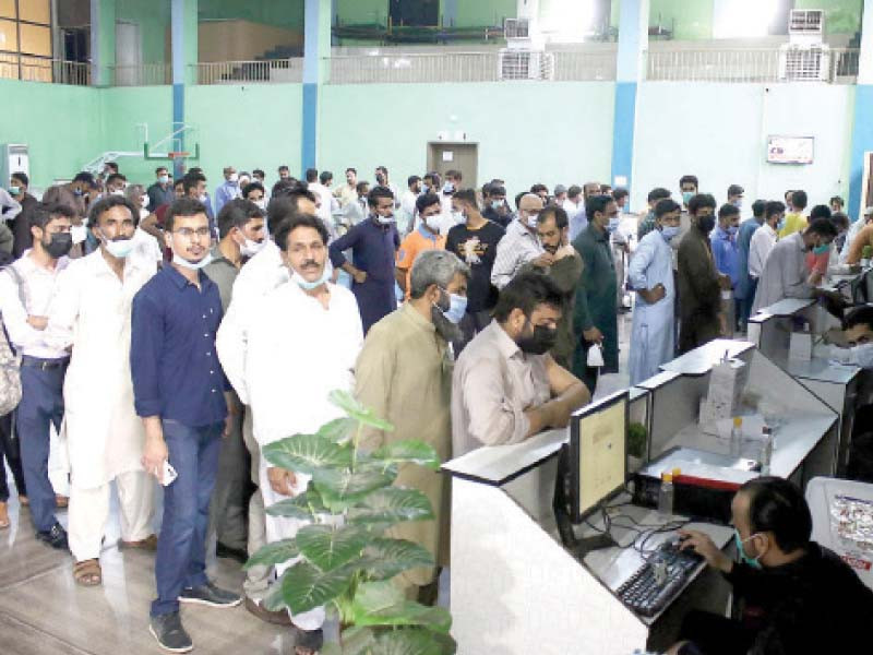 people patiently wait in a queue for their anti covid jabs at a vaccination centre in rawalpindi photo inp