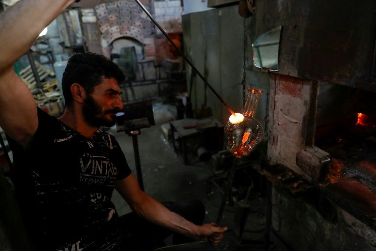 a glass blower shapes traditional water pitchers at the uniglass factory in tripoli north lebanon where glass broken in the beirut port explosion is being repurposed afp