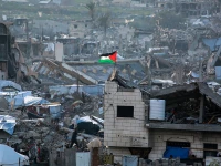 a palestinian flag flutters amid the ruins of buildings in beit lahia in northern gaza on march 4 2025 photo afp