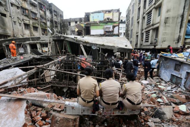 police officers watch rescue operations after a three storey building collapsed in bhiwandi on the outskirts of mumbai india september 21 2020 reuters