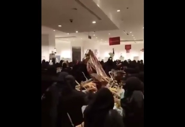 Women grabbing clothes off the racks. SCREENGRAB