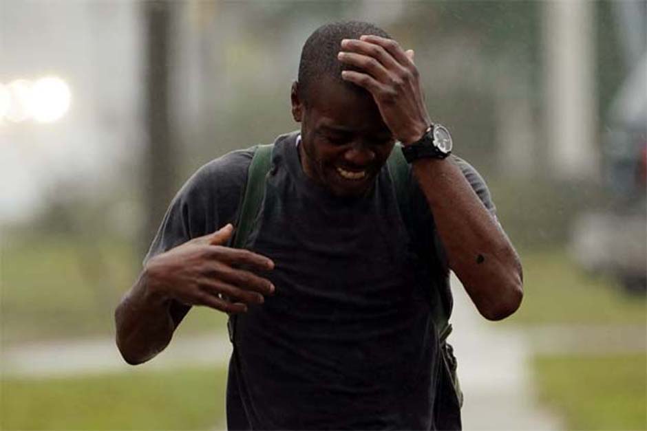 Tahrike Shaw sings, prays as he walks along the sidewalk as Hurricane Florence comes ashore in Wilmington, North Carolina PHOTO: AFP