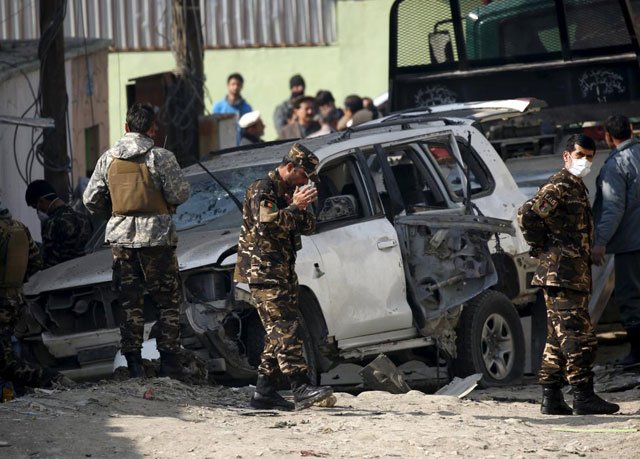 afghan security personnel keep watch at the site of a suicide blast that targeted a senior member of afghanistan 039 s election commission in kabul november 28 2015 photo reuters