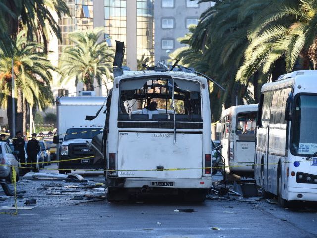 tunisian forensic police inspect the wreckage of a bus in the aftermath of a bomb attack on the vehicle which was transporting tunisia 039 s presidential guard in central tunis on november 25 2015 photo afp
