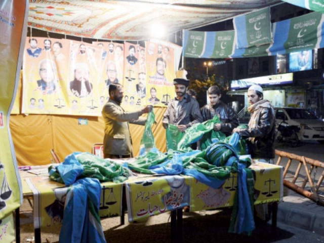 activists preparing party flags for election day activities photo huma choudhary express activists preparing party flags for election day activities photo huma choudhary express
