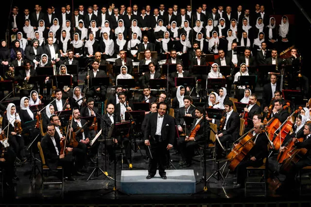 a file picture taken on march 16 2015 shows iranian conductor ali rahbari c and the tehran symphony orchestra greeted by the audience after performing at the vahdat hall in tehran photo afp a file picture taken on march 16 2015 shows iranian conductor ali rahbari c and the tehran symphony orchestra greeted by the audience after performing at the vahdat hall in tehran photo afp