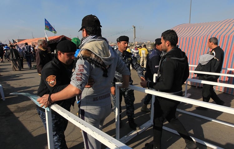 shia muslim pilgrims undergo security checks on a main road in baghdad 039 s dora district on november 30 2015 as tens of thousands of observant shias head on foot towards the holy city of karbala to take part in the arbaeen commemoration photo afp