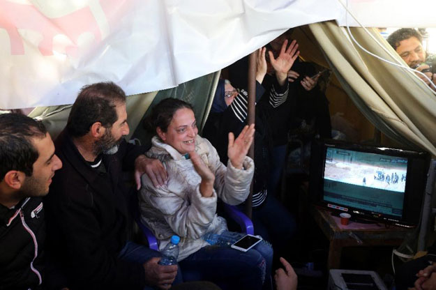 relatives of lebanese soldiers and policemen kidnapped by a terrorist group from the eastern border town of arsal last year watch news reports about the release of their loved ones in downtown beirut on december 1 2015 photo afp