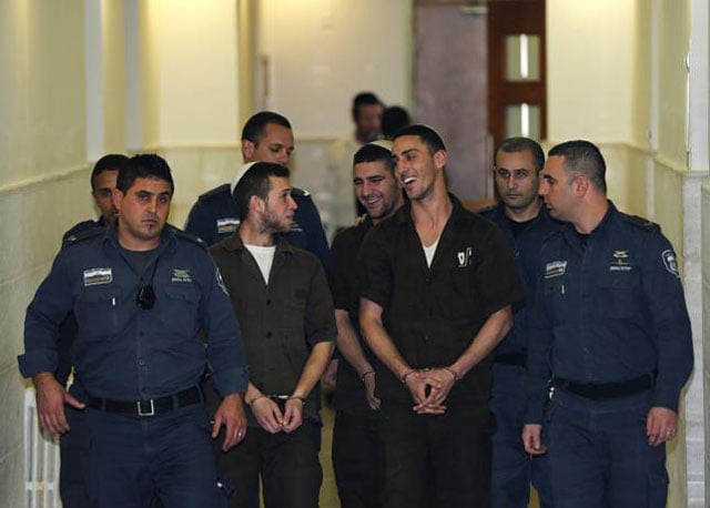 israeli prison guards escort far right activists yitzhak gabai nahman twito and shlomo twito at jerusalem district court december 15 2014 photo reuters