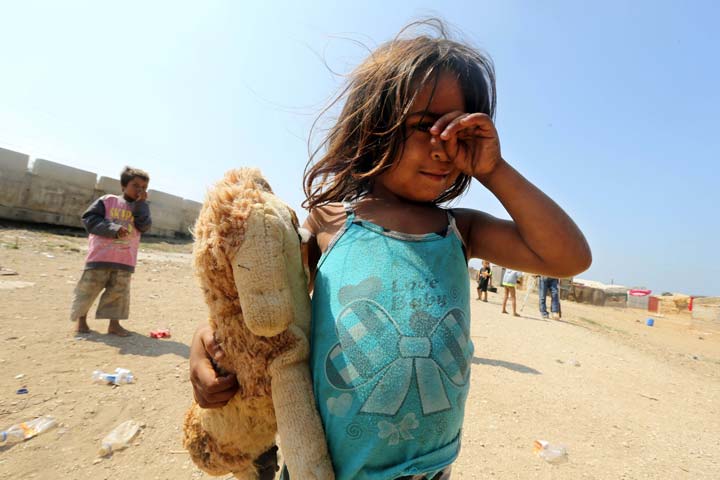 a syrian refugee girl gestures at an unofficial refugee camp in the area of arida north of beirut on june 15 2015 photo afp