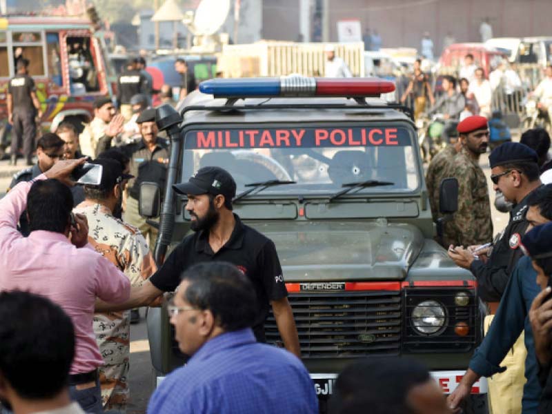 officials inspect the targeted military police jeep in karachi photo afp