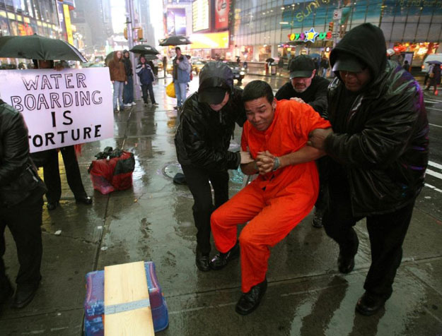 demonstrators hold a mock waterboarding torture of a prisioner on january 11 2008 photo afp