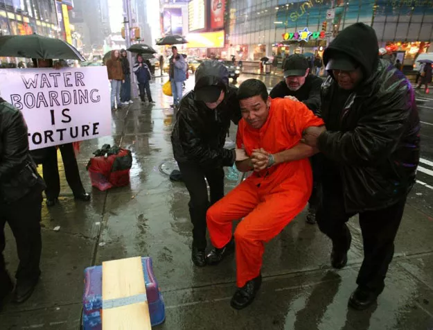 demonstrators hold a mock waterboarding torture of a prisioner on january 11 2008 photo afp demonstrators hold a mock waterboarding torture of a prisioner on january 11 2008 photo afp