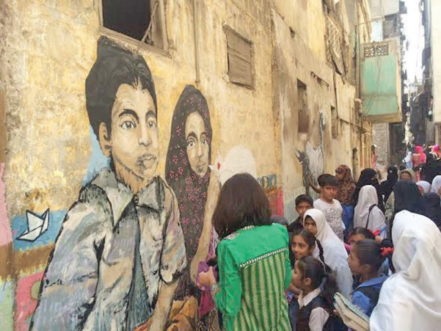 the fearless collective painted a few walls in lyari on wednesday morning with excited children watching them work the paintings were based on the theme play photo express the fearless collective painted a few walls in lyari on wednesday morning with excited children watching them work the paintings were based on the theme play photo express
