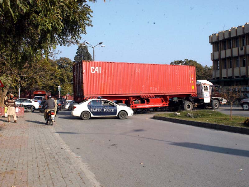 mourners attend a procession at g 6 imambargah top a container blocks a road photos waseem nazir