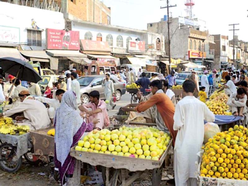 a number of vendors have encroached upon a road leaving little space for commuters and pedestrians in rawalpindi photo file