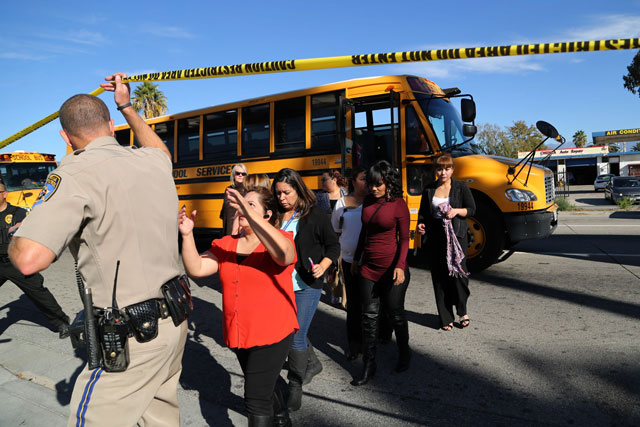 employees and other people are evacuated by bus from the site of a mass shooting at the inland regional centre on december 2 2015 in san bernardino california photo afp