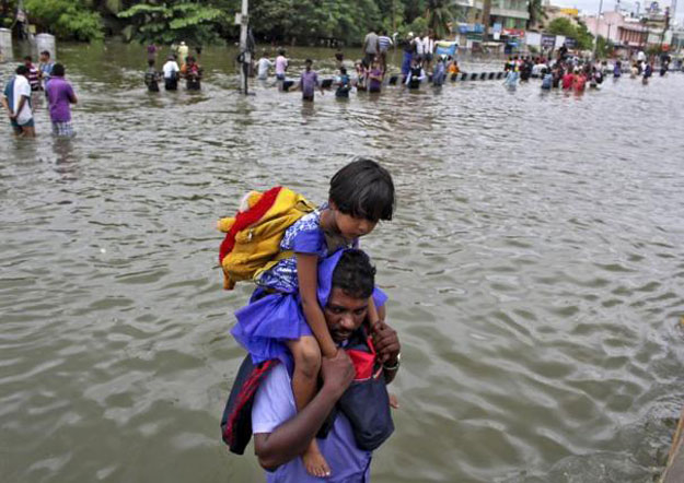 a man carries a girl through a flooded road in chennai december 2 2015 photo reuters