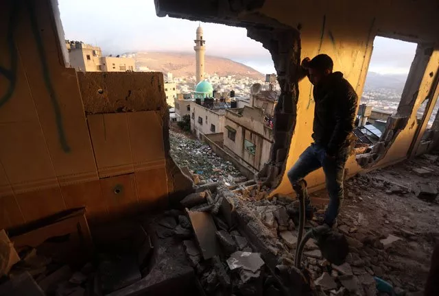 a palestinianm man looks at the rubble of the house of ragheb ahmad mohammad alawi a palestinian accused of masterminding the killing of a jewish israeli settler couple in the itmar settlement on october 1 after it was destroyed by israeli authorities in the west bank city of nablus early in the morning of december 3 2015 photo afp a palestinianm man looks at the rubble of the house of ragheb ahmad mohammad alawi a palestinian accused of masterminding the killing of a jewish israeli settler couple in the itmar settlement on october 1 after it was destroyed by israeli authorities in the west bank city of nablus early in the morning of december 3 2015 photo afp