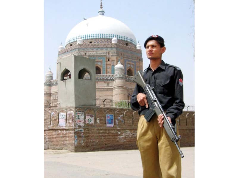 a policeman stands guard in front of the tomb of shah rukne alam in multan photo inp