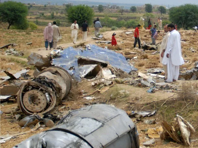 onlookers are seen at the site of the bhoja air boeing 737 crash in the outskirts of islamabad on april 25 2012 photo afp onlookers are seen at the site of the bhoja air boeing 737 crash in the outskirts of islamabad on april 25 2012 photo afp