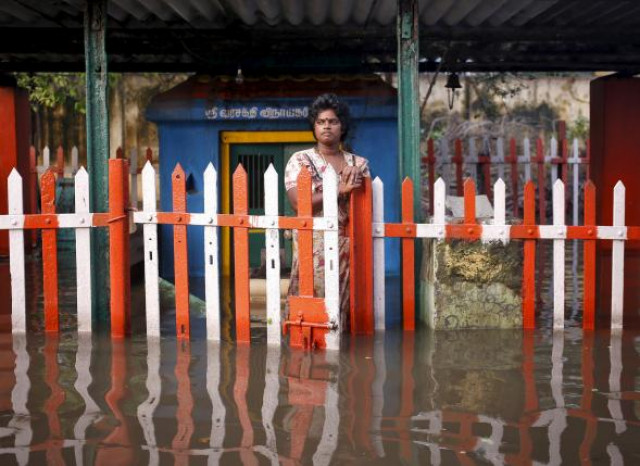a woman stands at a fenced gate of a partially submerged temple in chennai india december 4 2015 photo reuters a woman stands at a fenced gate of a partially submerged temple in chennai india december 4 2015 photo reuters