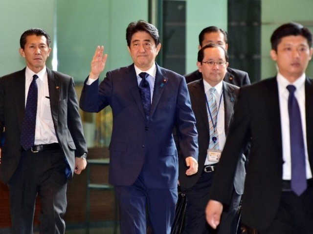 japan 039 s prime minister shinzo abe c waves upon his arrival at his official residence in tokyo on september 18 2015 photo afp