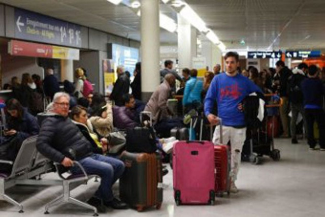 passengers wait at orly airport outside paris photo afp passengers wait at orly airport outside paris photo afp