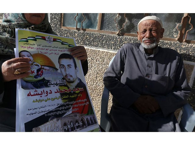the father of saad dawabsha portrait l who was killed alongside his toddler and his wife when their house was firebombed by jewish extremists on july 31 2015 in the israeli occupied west bank weeps near a poster bearing slogans and images of his son and grandson on december 4 2015 in village of duma photo afp the father of saad dawabsha portrait l who was killed alongside his toddler and his wife when their house was firebombed by jewish extremists on july 31 2015 in the israeli occupied west bank weeps near a poster bearing slogans and images of his son and grandson on december 4 2015 in village of duma photo afp