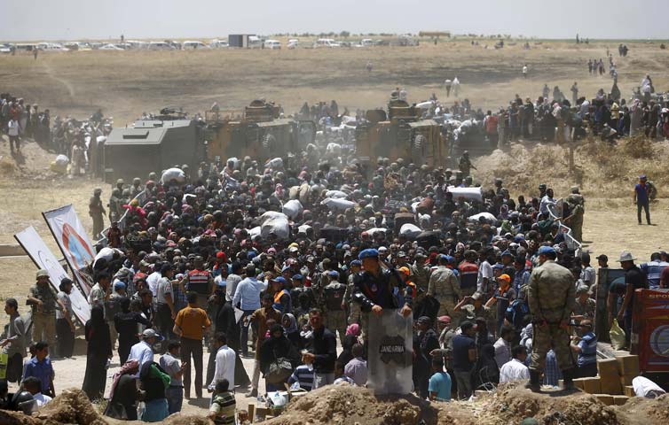 syrian refugees wait for transportation after crossing into turkey from the syrian town of tal abyad near akcakale in sanliurfa province turkey june 10 2015 photo reuters