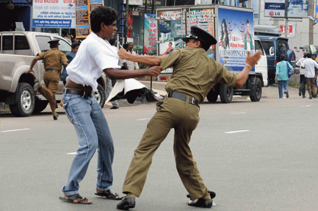 sri lankan police officer beating a protester on october 29 2015 photo afp sri lankan police officer beating a protester on october 29 2015 photo afp