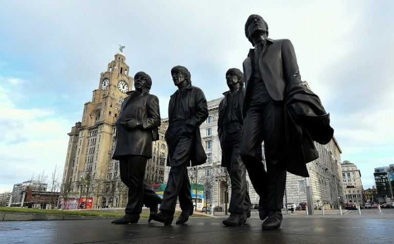 a new statue of the beatles featuring l r paul mccartney george harrison ringo starr and john lennon unveiled in liverpool northwest england on december 4 2015 photo afp