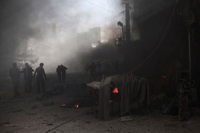 syrian men stand amid debris following reported air strikes by government forces in the town of jisreen in the rebel held region of eastern ghouta on the outskirts of damascus on december 4 2015 photo afp syrian men stand amid debris following reported air strikes by government forces in the town of jisreen in the rebel held region of eastern ghouta on the outskirts of damascus on december 4 2015 photo afp