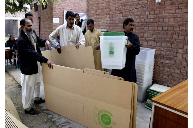 polling staff busy in receiving ballot papers ballot boxes and other materials from the ecp for local bodies elections photo app