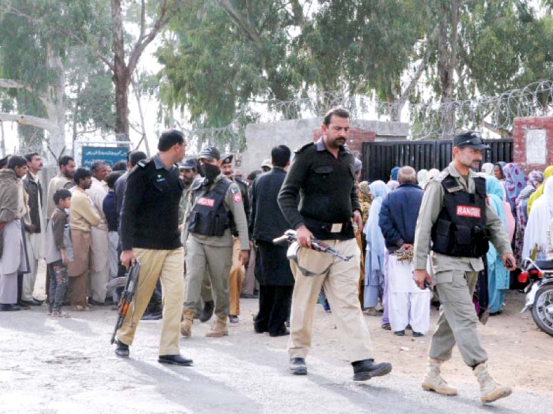 left security personnel stand outside a polling station photos agha mehroz express