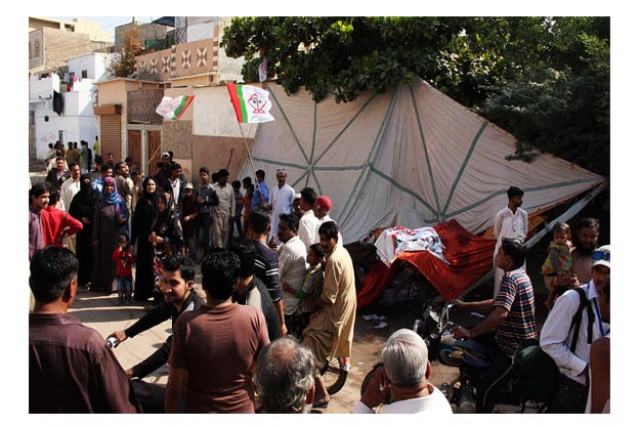 people gather at an election camp after clashes between two rival groups in landhi area photo online people gather at an election camp after clashes between two rival groups in landhi area photo online