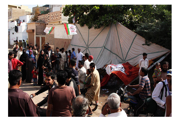 people gather at an election camp after clashes between two rival groups in landhi area photo online