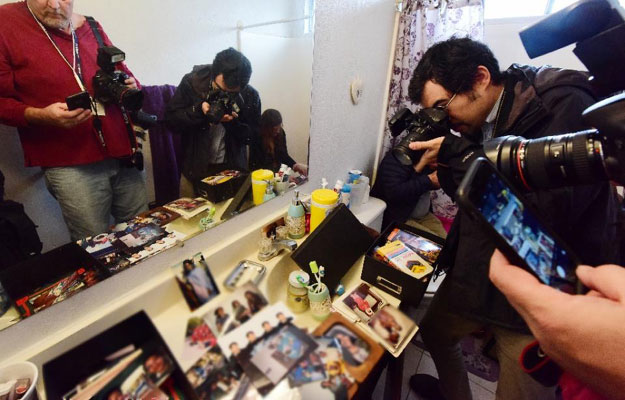 journalists take photos inside the bathroom in the home of shooting suspect syed farook on december 4 2015 in redlands california photo afp