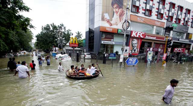 indian residents make their way through floodwaters in chennai on december 3 2015 thousands of rescuers raced to evacuate residents from deadly flooding as india 039 s prime minister narendra modi went to the southern state of tamil nadu to survey the devastation more than 40 000 people have been rescued in recent days after record rains lashed the coastal state worsening weeks of flooding that has killed 269 people photo afp