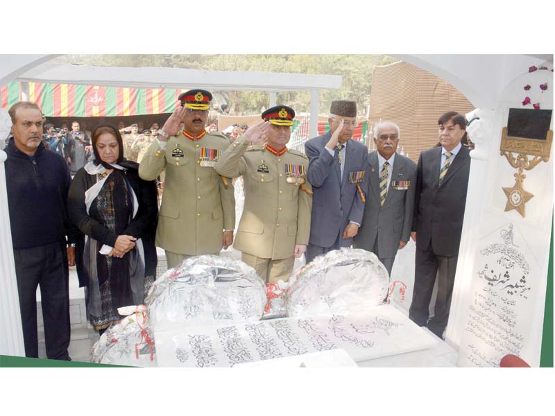 army men salute at the grave of major shabbir sharif after offering prayers photo ispr