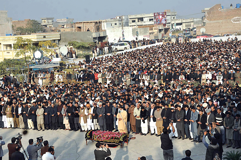 a large number of people including parliamentarians attended the funeral at raja s family graveyard in dhamial photo zafar aslam express