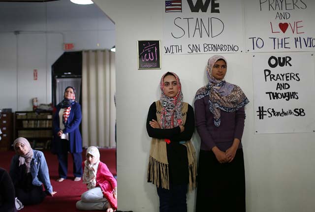 redlands ca   december 06 khadija zadeh l and noora siddiqui stand together as they attend an interfaith service at the islamic community center of redlands for the victims of the mass shooting at the inland regional center during on december 6 2015 in redlands california photo afp