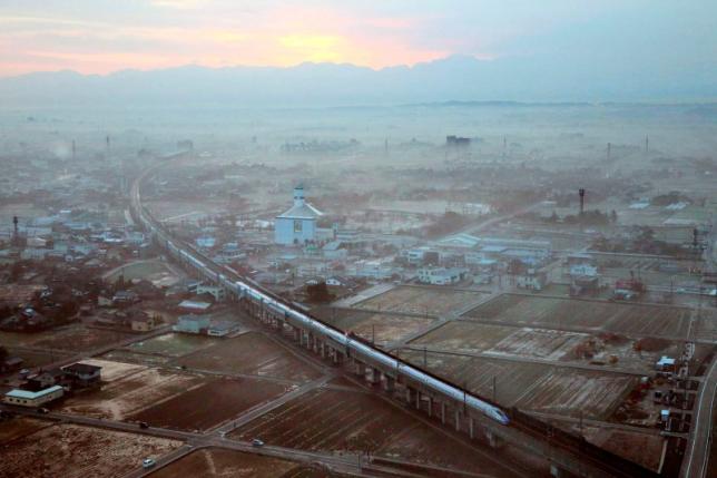 the first train of the new hokuriku shinkansen or bullet train bound for tokyo runs near shin takaoka station in takaoka toyama prefecture march 14 2015 in this aerial view photo taken by kyodo photo reuters