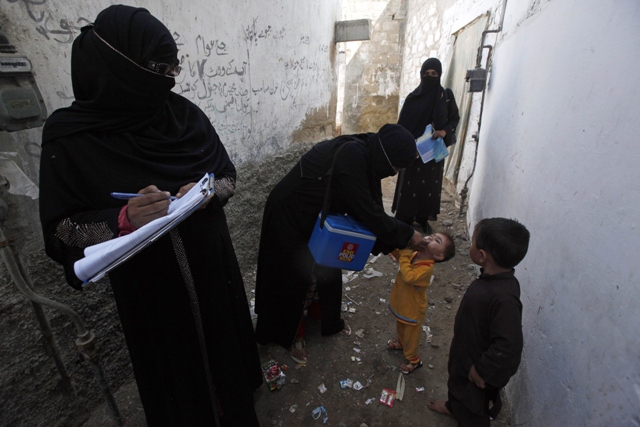 a file photo of health workers administrating polio vaccine to children photo reuters