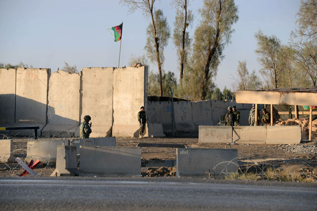 afghan security personnel stand guard near the airport complex in kandahar on december 9 2015 photo afp